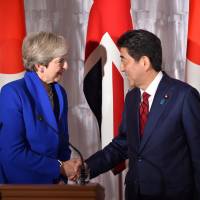British Prime Minister Theresa May shakes hands with her Japanese counterpart, Shinzo Abe, following their joint news conference Thursday at the State Guesthouse in Tokyo\'s Akasaka district. | POOL / VIA REUTERS