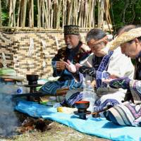 Ainu people pray for their ancestors in Shiranuka, Hokkaido, in August 2015. | KYODO