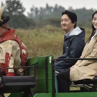 Prince Akishino and his daughter, Princess Mako, ride in a buggy during a visit to Karikas Csarda, a traditional inn in the Great Hungarian Plains near Bugac, 110 km southeast of Budapest, on Sunday. | AP