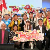 People working in the anime industry and officials from municipalities selected for the Anime Tourism 88-Stop Pilgrimage pose during an event at Makuhari Messe convention center in Chiba on Saturday. | KAZUAKI NAGATA
