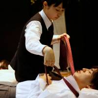 A funeral undertaker dresses a model during an encoffinment competition at Life Ending Industry EXPO 2017 in Tokyo. | REUTERS