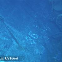 What appears to be the painted hull number \"35\" appears in this image shot by a remotely operated underwater vehicle. Based on the curvature of the hull section, this seems to be the port side of the ship. | COURTESY OF PAUL G. ALLEN