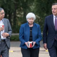 Bank of Japan Gov. Haruhiko Kuroda, Federal Reserve chief Janet Yellen and Mario Draghi, president of the European Central Bank, walk the grounds at the Jackson Hole economic symposium in Moran, Wyoming, on Friday. | BLOOMBERG