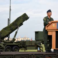 Lt. Gen. Hiroaki Maehara, the commander of the Air Self-Defense Forces, 
delivers a speech in front of Japanese Air Self Defense Force (JASDF) demonstrating the training to utilize 
Lt. Gen. Hiroaki Maehara, commander of the ASDF’s Air Defense Command, delivers a speech Tuesday during a test deployment of missile interceptors at Yokota Air Base in Tokyo, a few hours after a missile launch by North Korea over Japanese territory. | SATOKO KAWASAKI