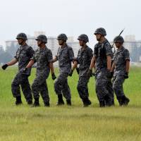 Air Self-Defense Force personnel take part in a drill to mobilize a Patriot Advanced Capability-3 missile unit on Tuesday at the U.S. Air Force\'s Yokota Air Base in suburban Tokyo. | SATOKO KAWASAKI