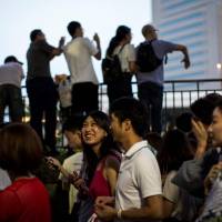 People walking along the Sumida River during a summer festival in Tokyo\'s Asakusa neighborhood on Aug. 12. | AFP-JIJI