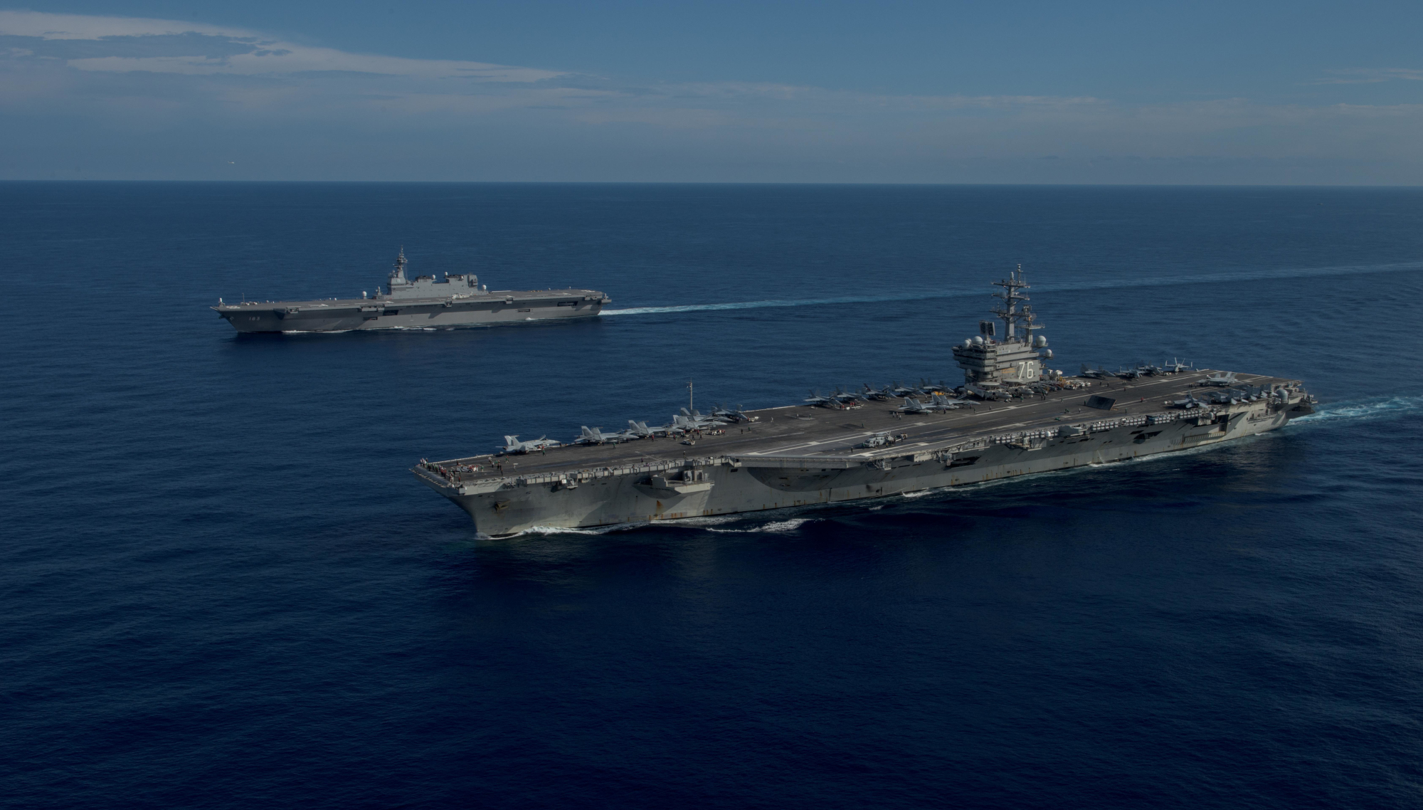 The USS Ronald Reagan (foreground) and the Maritime Self-Defense Force helicopter destroyer JS Izumo sail in formation during a combined exercise involving the MSDF and U.S. Navy on June 15. | NAVY MEDIA CONTENT SERVICES