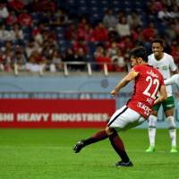 Urawa Reds midfielder Yuki Abe scores from the penalty spot on Tuesday at Saitama Stadium. | AFP-JIJI