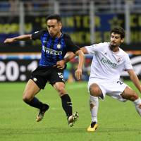 Inter Milan\'s Yuto Nagatomo (left), seen in action on Aug. 20 against Fiorentina, is questionable for Japan\'s World Cup qualifier against Australia on Thursday. | AFP-JIJI