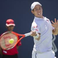 Kei Nishikori hits a return against Gael Monfils during the second round of the Rogers Cup in Montreal on Aug. 9. On Wednesday, Nishikori announced he will miss the remainder of the season because of a wrist injury. | AP