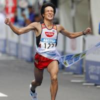 Akinobu Murasawa crosses the fininsh line first to win the Hokkaido Marathon on Sunday in Sapporo. | KYODO