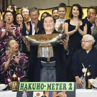 Hakuho celebrates after his victory in the Nagoya Grand Sumo Tournament in July. | KYODO