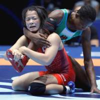 Haruna Okuno competes with Nigeria\'s Odunayo Folasade Adekuoroye in the gold medal match in the 55-kg division on Wednesday. | REUTERS