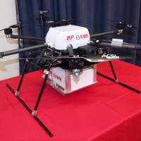 Japan Post Co. is considering using drones like this to move packages between post offices amid the shortage of delivery workers. | KYODO