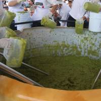 Volunteers from a culinary school mix mashed avocados as they attempt to set a new Guinness World Record for the largest serving of guacamole in Concepcion de Buenos Aires, Jalisco, Mexico, Sunday. | REUTERS