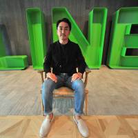 Line CEO Takeshi Idezawa poses at his office in Shinjuku, Tokyo, on Aug. 8. The maker of Japan\'s most popular messaging app says the future of its business is AI. | YOSHIAKI MIURA