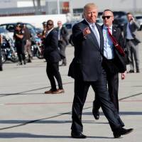 U.S. President Donald Trump walks to board Air Force One to return to Washington from Indianapolis International Airport in Indianapolis Wednesday. | REUTERS