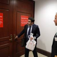 Twitter\'s Carlos Monje, public policy and philanthropy director, tries the door with Colin Crowell, head of global public policy, to enter a closed door meeting with the House Intelligence Committee on Capitol Hill Thursday in Washington. Officials from Twitter are on Capitol Hill as part of the House and Senate investigations into Russian interference in the 2016 election. | AP