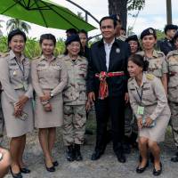 Thai Prime Minister Prayuth Chan-ocha poses for a photo with local government officers at a farming school in Thailand\'s Suphan Buri province on Sept. 18. | REUTERS