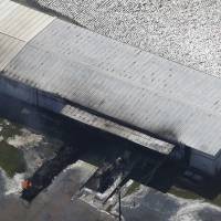 A fire burns at the flooded plant of French chemical maker Arkema SA in Crosby, Texas, Thursday. | REUTERS