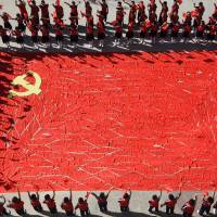 Students stand around a flag of the Chinese Communist Party made of red scarves ahead of the party\'s 19th National Congress, at a primary school in Linyi, Shandong province, on Sept. 1. | REUTERS