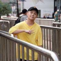 Li Yijie, a member of the Sichuan-based rap group Tianfu Shibian, poses for a photo ahead of an interview in Beijing on Aug. 10. | REUTERS