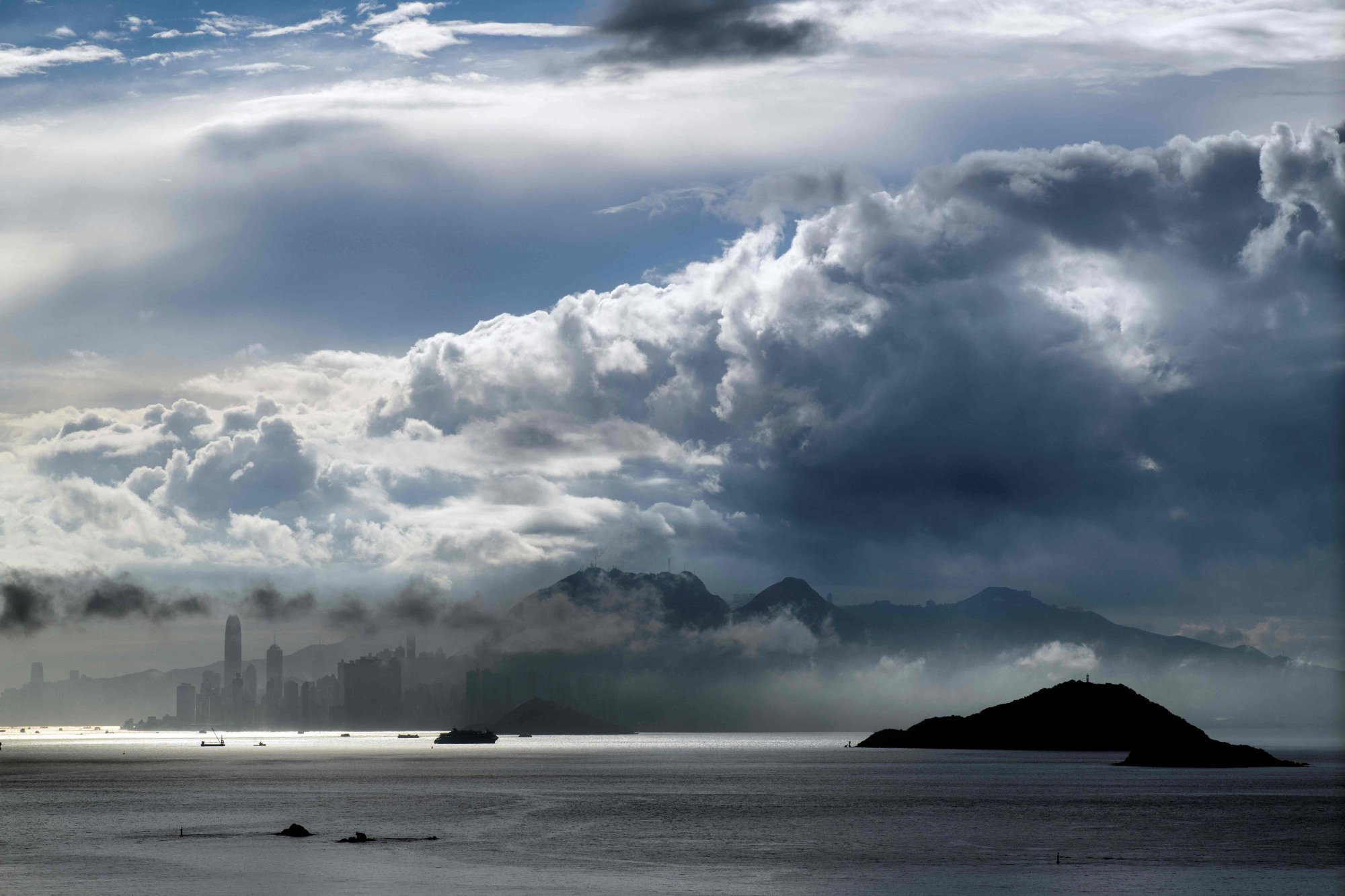 Moisture-laden clouds roll over Hong Kong island early Friday. | AFP-JIJI
