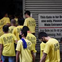 Detainees enter a government building to attend a court hearing at a Regional Trial court in Quezon City, Metro Manila, in June. | REUTERS