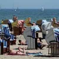 People sunbathe at the Baltic Sea beach of Travemuende in this file photo. | REUTERS