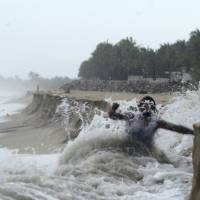 A man fights against waves caused by approaching Hurricane Max that took away part of the beach in Pie de La Cuesta, on the outskirts of Acapulco, Guerrero state, Mexico, Thursday. Max has strengthened into a Category 1 hurricane off Mexico\'s southern Pacific coast and is forecast to make landfall later Thursday along the coast of Guerrero state. It\'s a region that includes the resort city of Acapulco. | AP