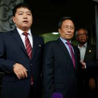 North Korean Ambassador to Mexico Kim Hyong Gil (center) stands at the door of the North Korean Embassy in Mexico City on Friday after addressing the media. | REUTERS