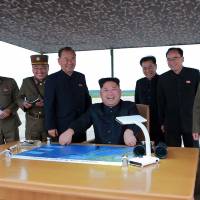 North Korean leader Kim Jong Un watches the launch of an intermediate-range ballistic missile in Pyongyang on Tuesday. | AFP-JIJI