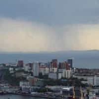 Rain clouds pass over a commercial port in Vladivostok, Russia, on June 8. North Korean ships sailing from Vladivostok and nearby Nakhodka appear to be evading U.N. sanctions. | REUTERS