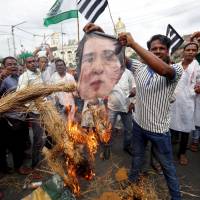 People burn an effigy of Aung San Suu Kyi in Kolkata on Monday over what protesters called the killings of Rohingya in Myanmar. | REUTERS
