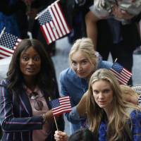Family members look for relatives leaving an oath-taking ceremony for new U.S. citizens, in Los Angeles on Wednesday. | AP
