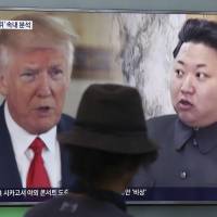 A man watches a TV screen showing U.S. President Donald Trump and North Korean leader Kim Jong Un during a news program at Seoul Train Station in the South Korean capital on Aug. 10. | AP