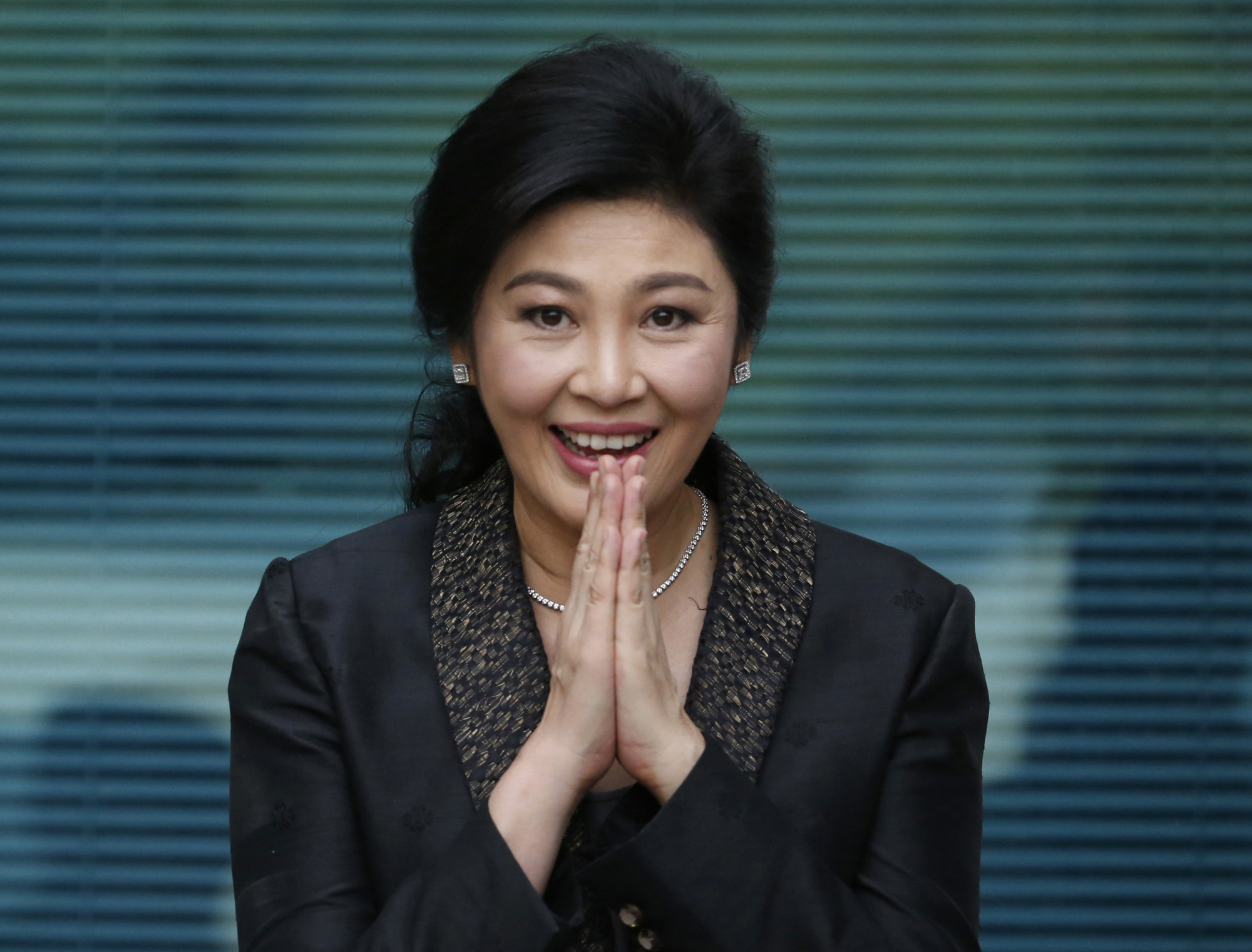 Former Thai Prime Minister Yingluck Shinawatra arrives at the Supreme Court to make her final statements in a trial on a charge of criminal negligence in Bangkok on Aug. 1. | AP