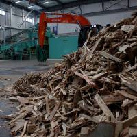 Wood construction waste, set to be made into wood chips, is seen at the Eco Green Holdings factory in Tokyo. | REUTERS