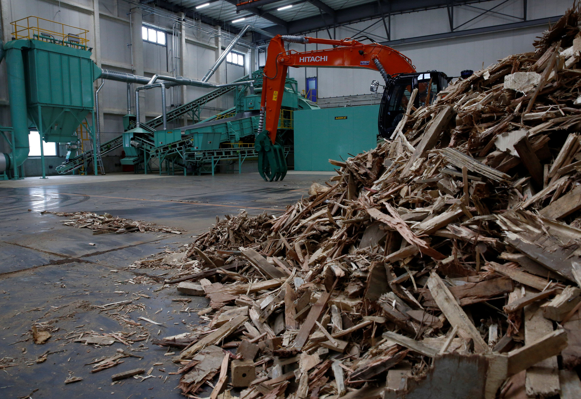 Wood construction waste, set to be made into wood chips, is seen at the Eco Green Holdings factory in Tokyo. | REUTERS