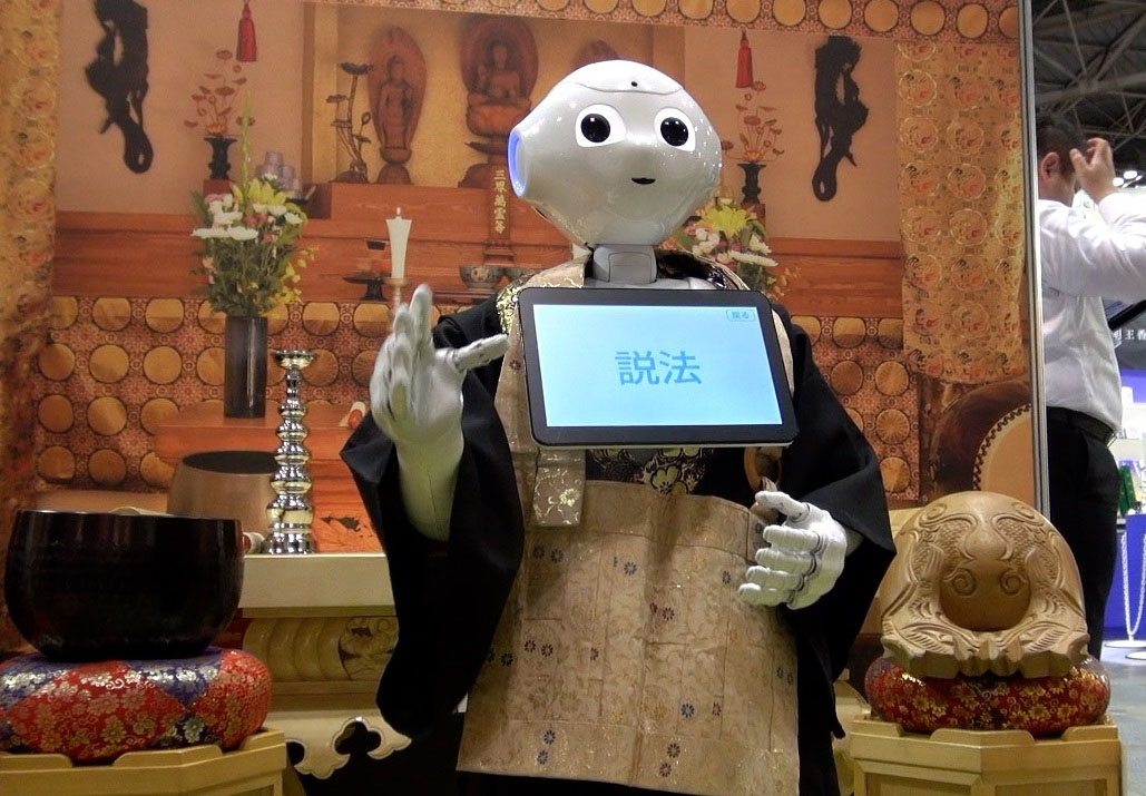 Pepper, the humanoid robot created by SoftBank Robotics, recites Buddhist sutras during the Life Ending Industry Expo 2017 in Tokyo on Aug. 23. | KAZUHIRO KOBAYASHI
