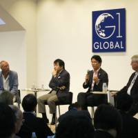 Hiromichi Mizuno (third from left), chief investment officer at GPIF, speaks during a session of the G1 Global Conference at Globis University in Tokyo on Monday. Other panelists (from left) are Jesper Koll, CEO of Wisdom Tree Japan; Heizo Takenaka, professor emeritus at Keio University; and Richard McCormack, senior adviser at the Center for Strategic and International Studies. | KAZUAKI NAGATA