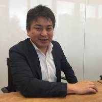 Munekatsu Ota, CEO of Rakuten Lifull Stay Inc., speaks at the company\'s office in Tokyo earlier this month. | ALEX MARTIN