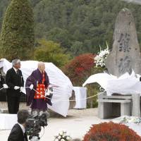 A monument is unveiled Wednesday in the Nagano Prefecture village of Otaki at the foot of Mount Ontake to mark the third anniversary of the volcano\'s eruption. | KYODO