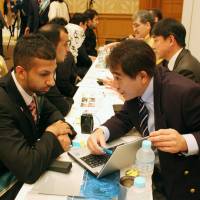 Saudi Arabian students are briefed about work opportunities at a job fair in Tokyo organized by the Saudi Arabian Embassy on March 13, 2014. About 30 companies participated. | KYODO