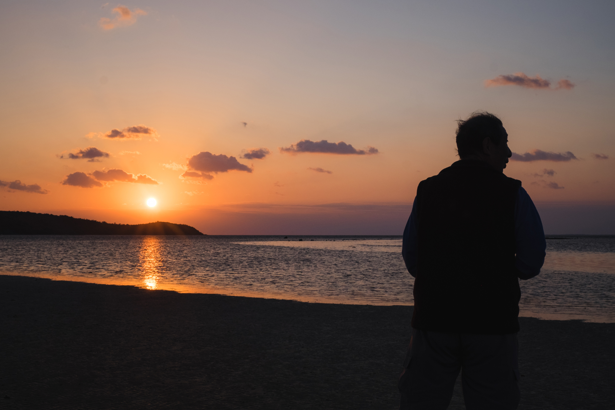 Healing light: Seasonal worker Takashi Matsuda watches the arrival of the sun and the tide. | LANCE HENDERSTEIN