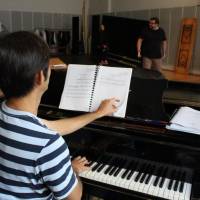 Behind the piano: Shiga accompanying the performers for a rehearsal. | HILKA BAUMAN