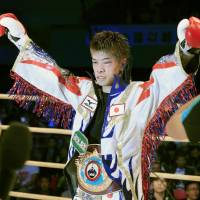 Kosei Tanaka celebrates after successfully defending his WBO light flyweight title on Wednesday night in Osaka. | KYODO