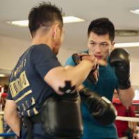 Ryota Murata punches his trainer\'s mitt during a training session on Friday in Tokyo ahead of his rematch with Hassan N\'Dam for the WBA middleweight title. | KAZ NAGATSUKA