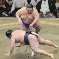 Takakeisho sends Goeido sprawling to the ground on Friday at the Autumn Grand Sumo Tournament. Takakeisho improved to 8-5, while Goeido maintained his top spot with a 10-3 record. | KYODO