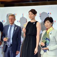 French Ambassador Laurent Pic (second from left) and Tokyo Gov. Yuriko Koike (right) pose for a photograph with Olympic athletes Kojiro Shiraishi (left) and Yukiko Ebata (second from right) at a reception in Tokyo on Sept. 14 following an announcement that Paris had been selected to host the 2024 Olympics. | COURTESY OF THE FRENCH EMBASSY